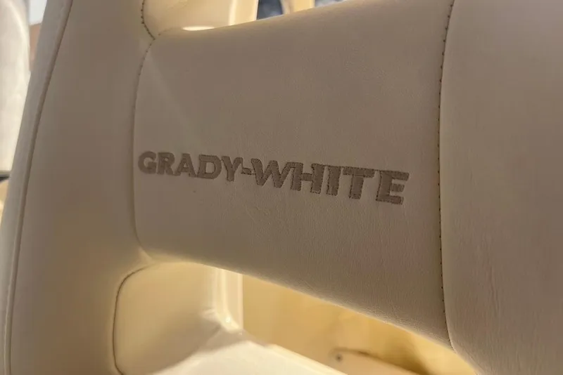 Slide: The Image of Captain's seat on 2023 Grady-White Adventure 218 boat, featuring luxurious white upholstery. - 10