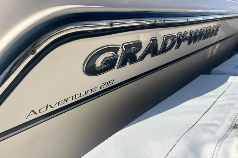 Slide: The Image of 2023 Grady-White Adventure 218 boat deck with Garmin equipment at marina. - 15