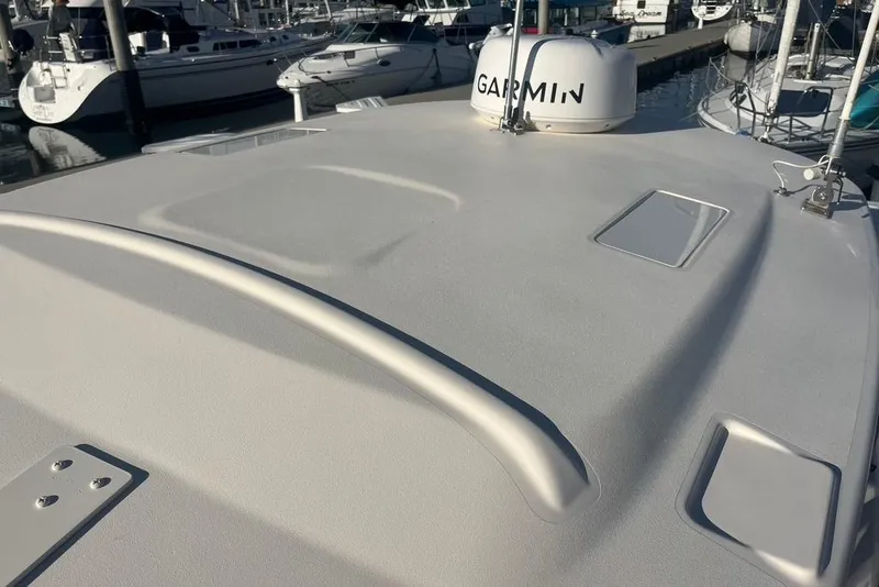 Slide: The Image of Rod holders on a 2023 Grady-White Adventure 218 boat at a marina. - 16