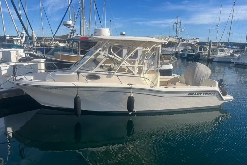 Slide: The Image of 2023 Grady-White Adventure 218 boat docked in marina, clear sky background. - 3