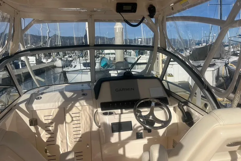 Slide: The Image of 2023 Grady-White Adventure 218 boat cockpit with Garmin navigation system at marina. - 5