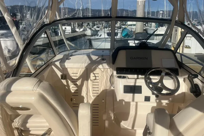 Slide: The Image of 2023 Grady-White Adventure 218 helm with steering wheel and control panel. - 6