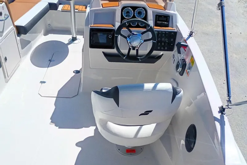 Slide: The Image of 2026 Starcraft SVX 211 OB boat cockpit with steering wheel and control panel. - 10