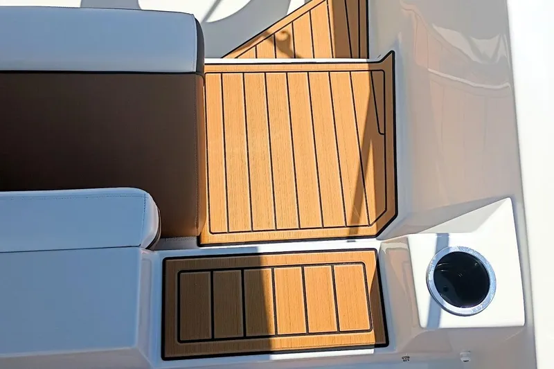Slide: The Image of 2026 Starcraft SVX 211 OB boat interior with teak flooring and cushioned seating. - 11
