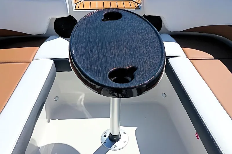 Slide: The Image of 2026 Starcraft SVX 211 OB boat interior with round table and cushioned seating. - 20