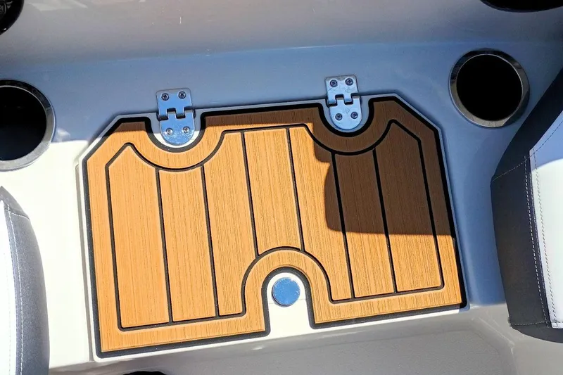 Slide: The Image of 2026 Starcraft SVX 211 OB boat interior with teak-style flooring and cup holders. - 25