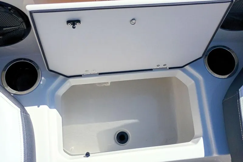 Slide: The Image of 2026 Starcraft SVX 211 OB boat storage compartment with cup holders. - 26