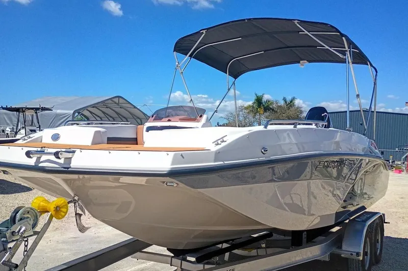 Slide: The Image of 2026 Starcraft SVX 211 OB boat on trailer under clear blue sky. - 3
