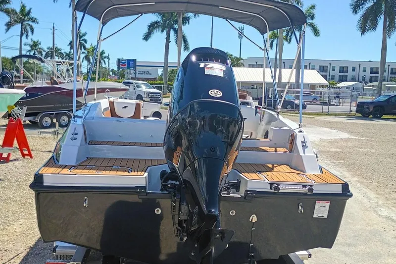 Slide: The Image of 2026 Starcraft SVX 211 OB boat with outboard motor, parked outdoors under sunny skies. - 31