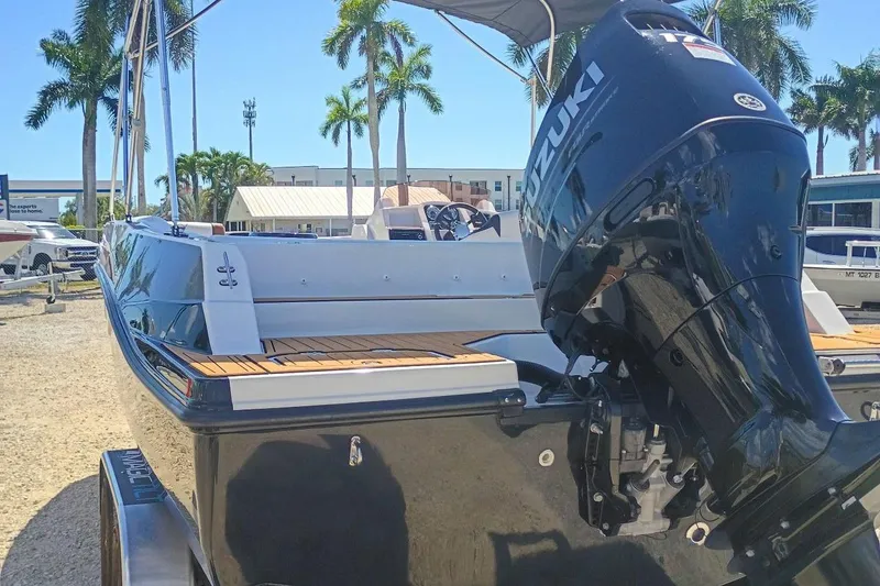 Slide: The Image of 2026 Starcraft SVX 211 OB boat with Suzuki outboard motor, parked outdoors. - 6