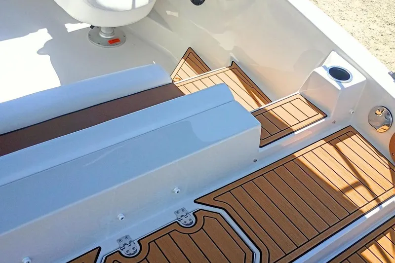 Slide: The Image of 2026 Starcraft SVX 211 OB boat interior with teak-style flooring and seating. - 8
