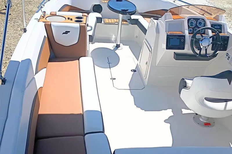 Slide: The Image of 2026 Starcraft SVX 211 OB boat interior with modern seating and steering console. - 9