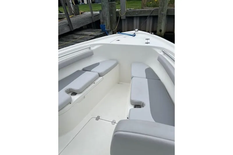 Slide: The Image of 2021 Mako 214 Center Console boat interior with cushioned seating. - 10