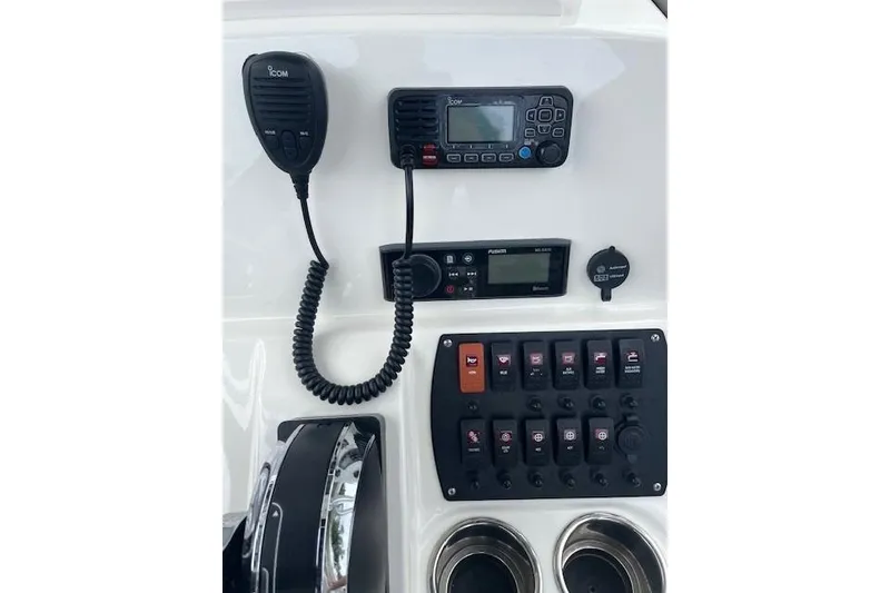 Slide: The Image of Control panel of 2021 Mako 214 Center Console boat with radio and switches. - 11