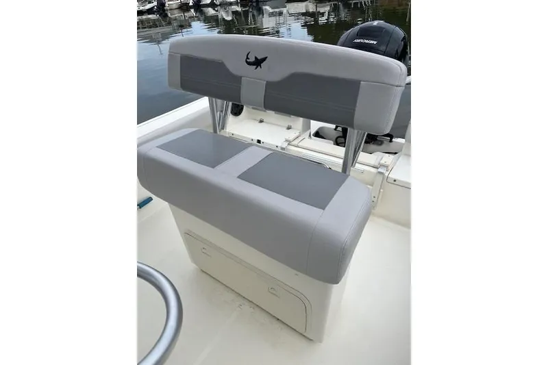Slide: The Image of 2021 Mako 214 Center Console boat seat with gray upholstery and shark logo. - 5