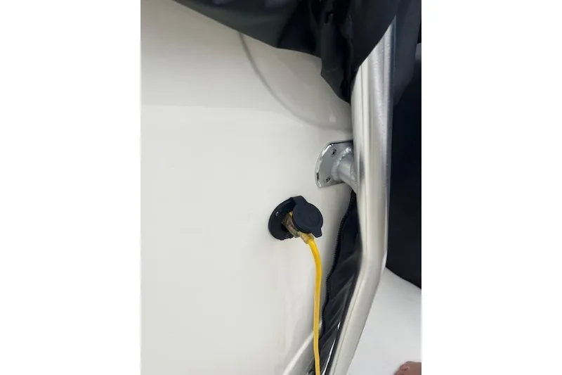 Slide: The Image of 2021 Mako 214 Center Console boat with yellow cable connection. - 94