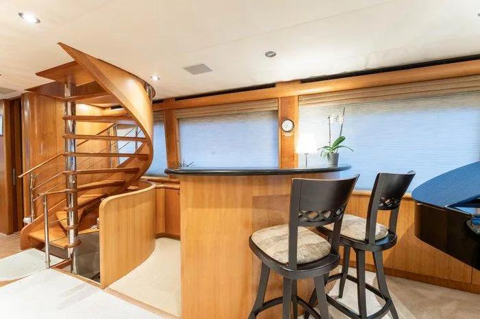 Slide: The Image of Luxurious interior of 2004 Cheoy Lee 81 Sport Yacht with spiral staircase and bar area. - 12