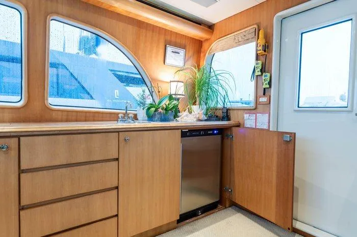 Slide: The Image of Interior of 2004 Cheoy Lee 81 Sport Yacht with wooden cabinetry and modern appliances. - 15