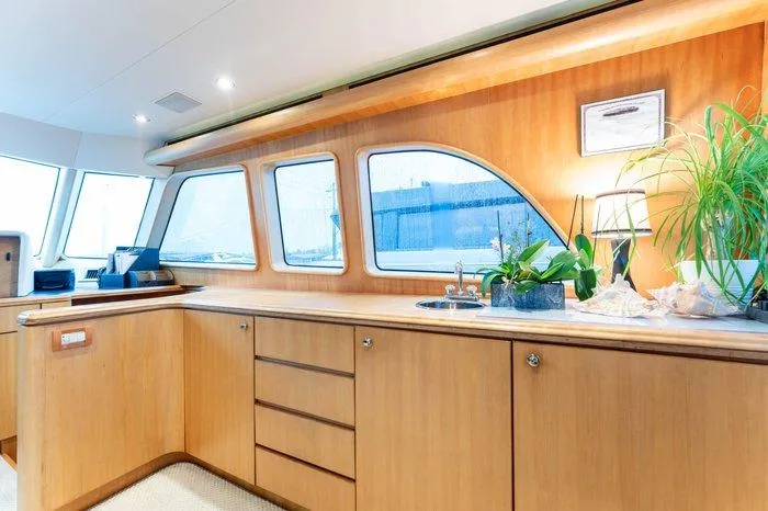 Slide: The Image of Luxurious interior of 2004 Cheoy Lee 81 Sport Yacht with elegant wood cabinetry and large windows. - 16