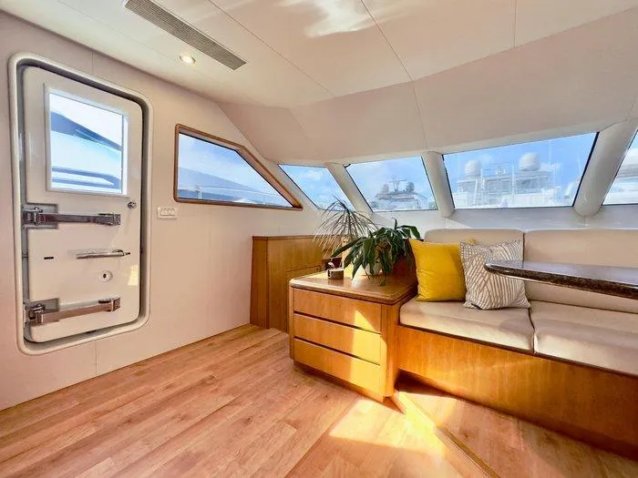Slide: The Image of Luxurious interior of 2004 Cheoy Lee 81 Sport Yacht with modern seating and natural light. - 18