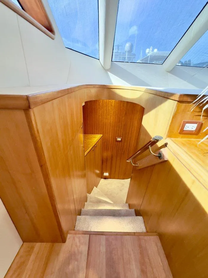Slide: The Image of Interior staircase of 2004 Cheoy Lee 81 Sport Yacht with wooden finish and skylight. - 21