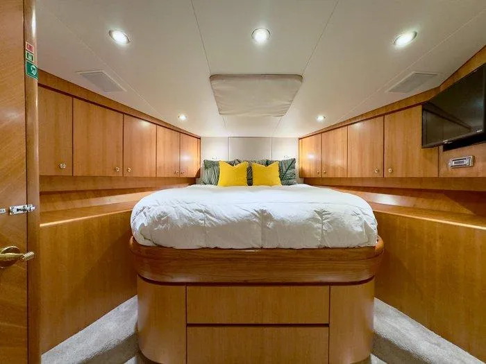 Slide: The Image of Luxurious bedroom interior of 2004 Cheoy Lee 81 Sport Yacht with wood paneling and cozy bedding. - 26