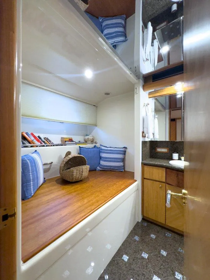 Slide: The Image of 2004 Cheoy Lee 81 Sport Yacht interior with cozy cabin, wooden accents, and nautical decor. - 28