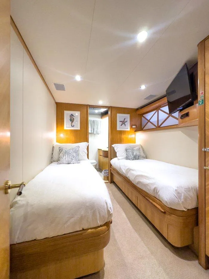 Slide: The Image of Luxurious twin cabin in 2004 Cheoy Lee 81 Sport Yacht, featuring modern decor and cozy beds. - 32