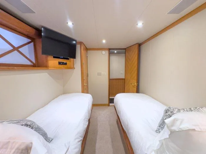 Slide: The Image of Twin bedroom in 2004 Cheoy Lee 81 Sport Yacht with modern decor and TV. - 33