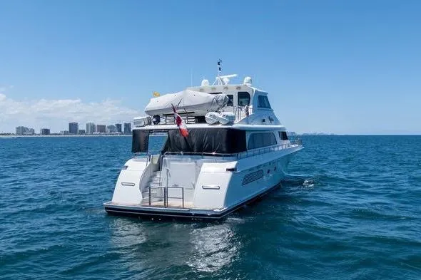 Slide: The Image of 2004 Cheoy Lee 81 Sport Yacht cruising on open water under clear skies. - 39