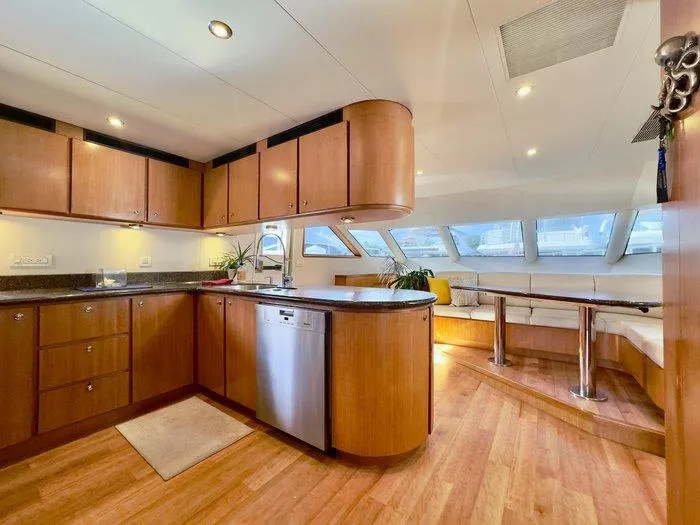 Slide: The Image of Luxurious interior of 2004 Cheoy Lee 81 Sport Yacht with modern kitchen and seating area. - 4