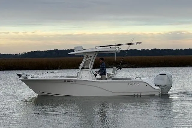 Slide: The Image of 2023 Sea Fox 248 Commander boat on calm water at sunset. - 0