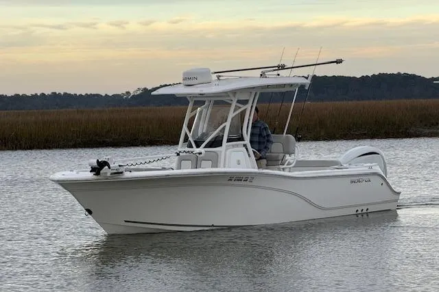 Slide: The Image of 2023 Sea Fox 248 Commander boat cruising on calm water at sunset. - 1