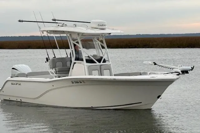Slide: The Image of 2023 Sea Fox 248 Commander boat on calm water, equipped with fishing rods and Garmin electronics. - 10