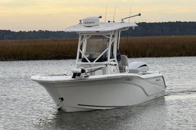 Slide: The Image of 2023 Sea Fox 248 Commander boat on calm water, featuring Garmin equipment. - 11