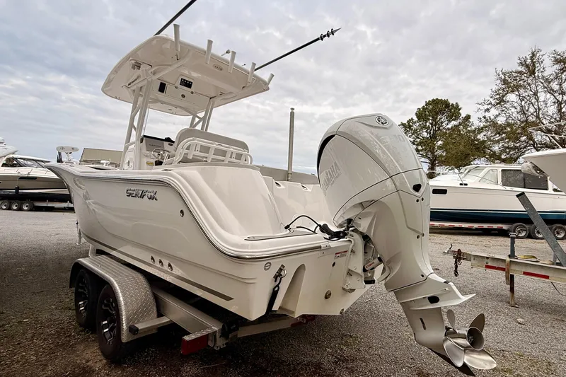 Slide: The Image of 2023 Sea Fox 248 Commander boat on trailer, featuring a powerful outboard motor. - 17