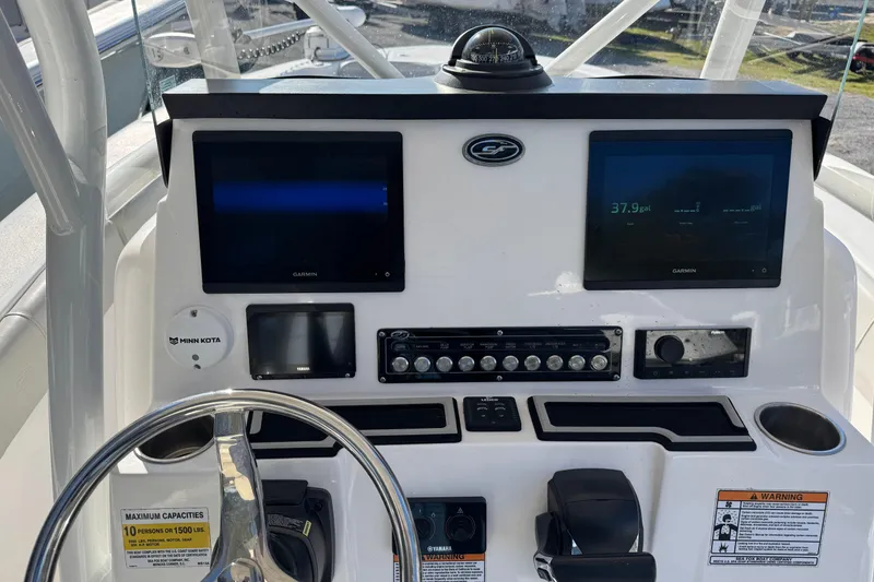 Slide: The Image of 2023 Sea Fox 248 Commander boat dashboard with Garmin displays and steering wheel. - 25