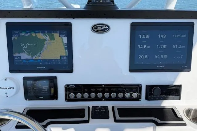 Slide: The Image of 2023 Sea Fox 248 Commander dashboard with dual Garmin displays and control panel. - 26