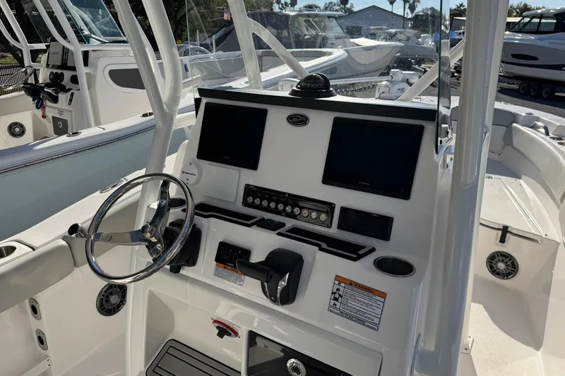 Slide: The Image of 2023 Sea Fox 248 Commander boat dashboard with steering wheel and electronic displays. - 27