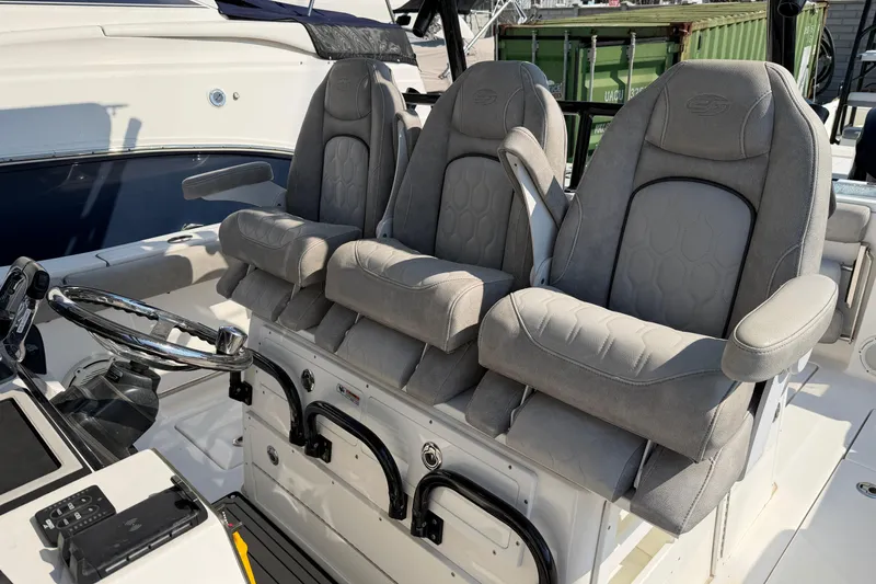 Slide: The Image of 2020 Sea Fox 328 Commander boat interior with three cushioned seats and steering wheel. - 16
