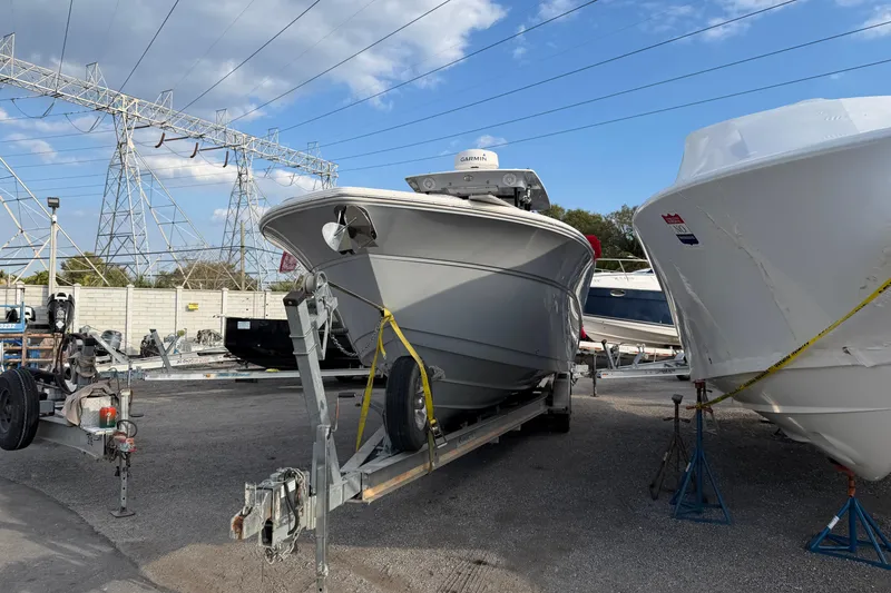 Slide: The Image of 2020 Sea Fox 328 Commander boat on trailer in storage yard under power lines. - 2