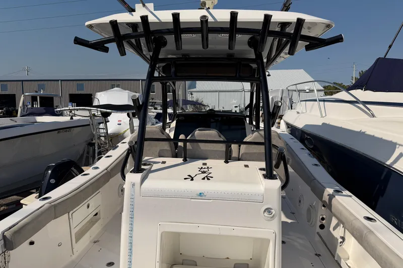 Slide: The Image of 2020 Sea Fox 328 Commander boat with T-top and rod holders, docked among other boats. - 20