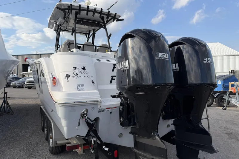 Slide: The Image of 2020 Sea Fox 328 Commander boat with twin Yamaha 350 engines, parked outdoors. - 4