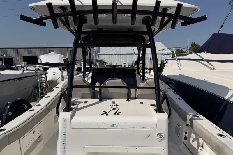 Slide: The Image of 2020 Sea Fox 328 Commander boat docked, showcasing spacious deck and seating area. - 7