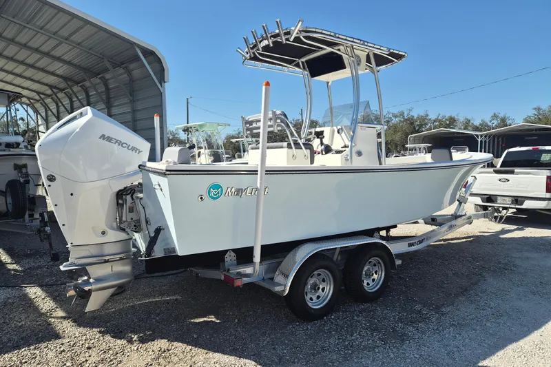 Slide: The Image of 2026 May-Craft 238 CC boat on trailer, displayed outdoors under cloudy sky. - 1