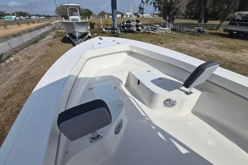 Slide: The Image of 2026 May-Craft 238 CC boat interior with seating and storage, displayed outdoors. - 10