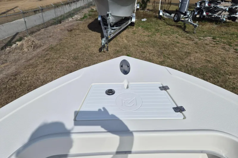 Slide: The Image of Bow view of 2026 May-Craft 238 CC boat on grassy area. - 12