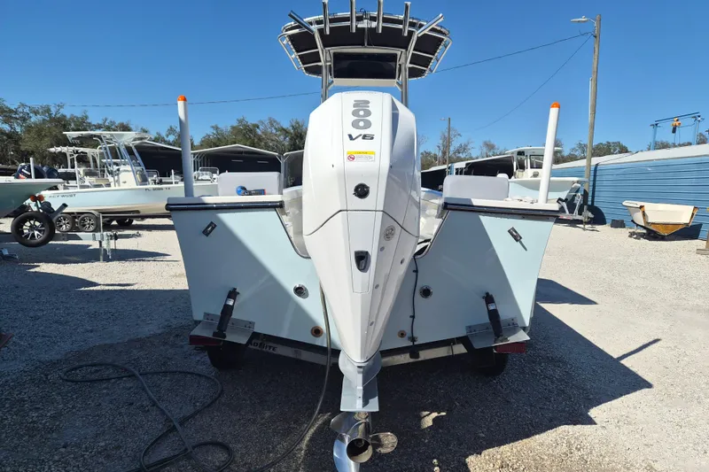 Slide: The Image of 2026 May-Craft 238 CC boat on trailer, featuring a powerful Mercury outboard motor. - 2