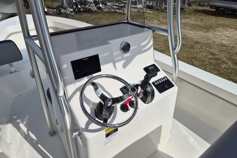 Slide: The Image of 2026 May-Craft 238 CC boat console with steering wheel and controls. - 6