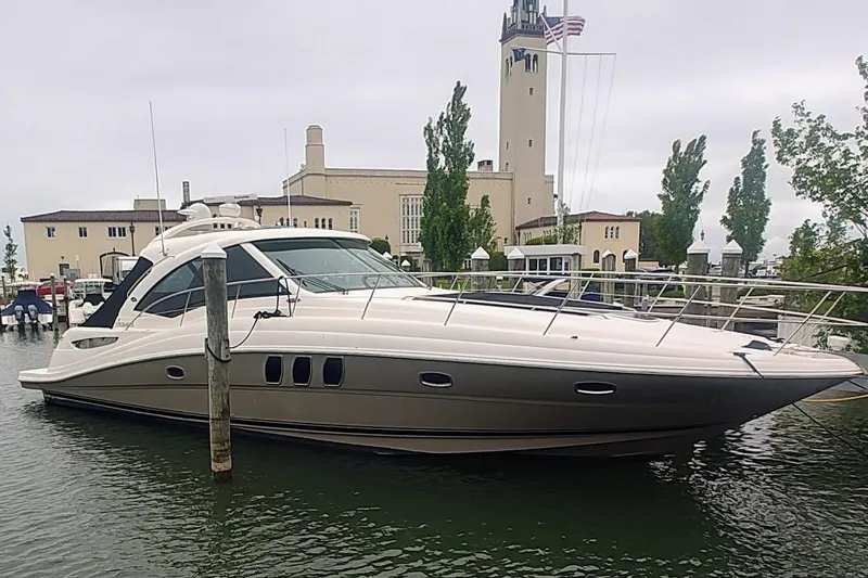 The Image of 2006 Sea Ray 48 Sundancer yacht docked near a historic building. - 0